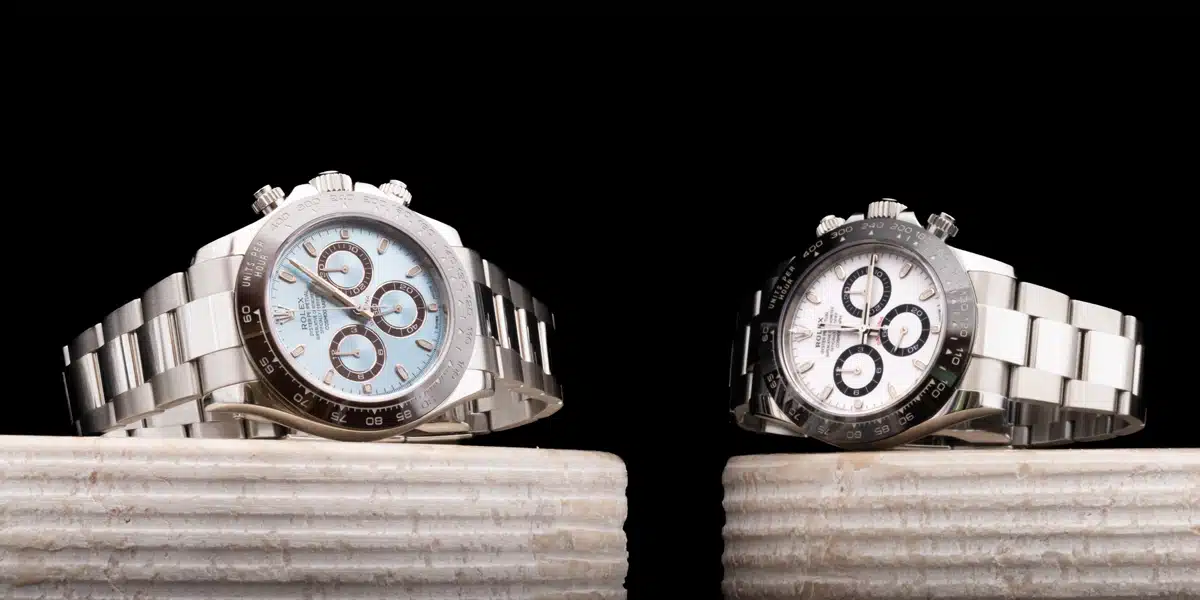 Luxury watches displayed against a black background